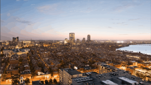 A view of Boston, including Mass General Hospital, downtown, the State House, and the Back Bay as seen from the West End during the night.