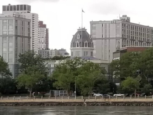 A large apartment building with a central octagon shaped section with a large cupola.