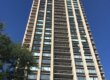 A tall residential tower from the ground looking up.