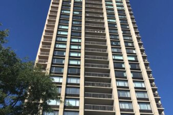 A tall residential tower from the ground looking up.