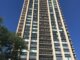 A tall residential tower from the ground looking up.