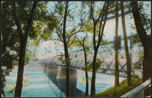 A colored photo of a railway bridge over a river with trees lining the river bank.