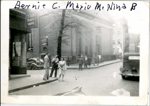 Three young people standing on a street corner, behind them is a church and to the left is a beauty shop.