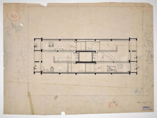 An architectural drawing showing three floors of an apartment complex with a central hallway.