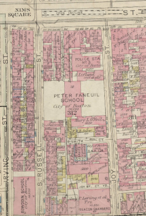 A fire insurance map of a block of a dense area of a city with a school in the center.