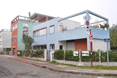 A light blue modern-style house with long horizontal windows.