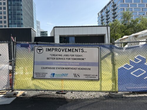 A fence with a sign that says T Improvements.