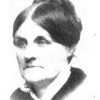 An older woman with a severe look and a harsh middle part.