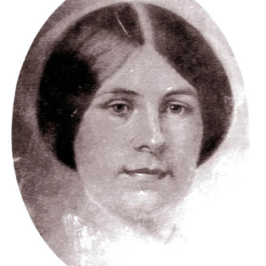 An oval portrait of a woman with a round hair-do. The bottom of the image is fading.